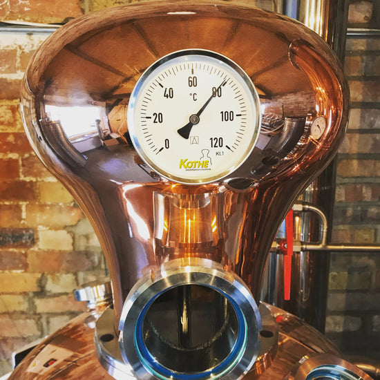 Copper still named Bluebelle, showing round temperature gauge ready to distil gin